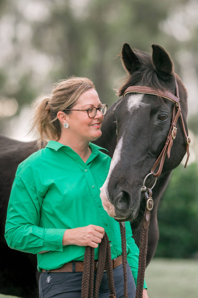 Black Australian Stock Horse bonding with his owner in an equestrian photography portrait by Trace Digital.